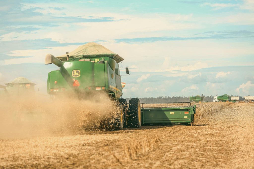 A combine harvester in action during a soybean harvest on a Brazilian farm.